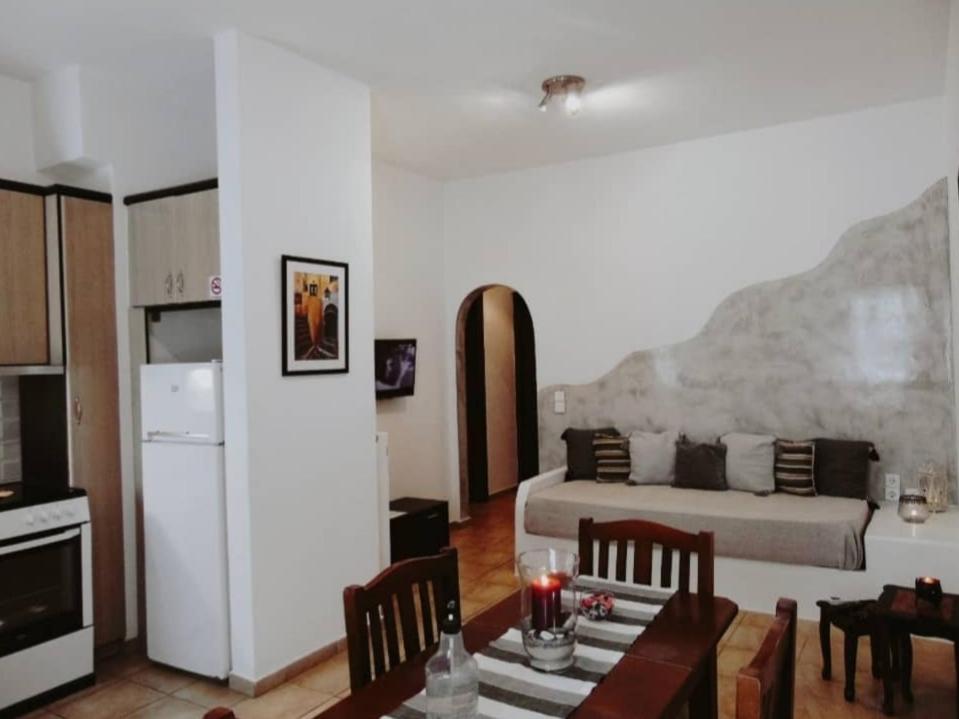 a living room with a couch and a table at Lefteris Houses in Karterados