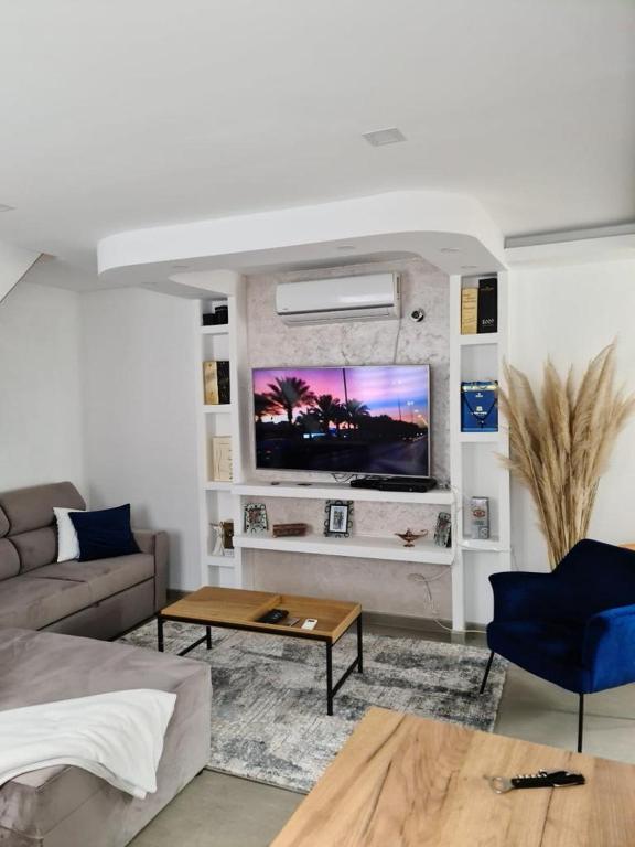 a living room with a couch and a tv on a wall at Sea side apartment in Kotor