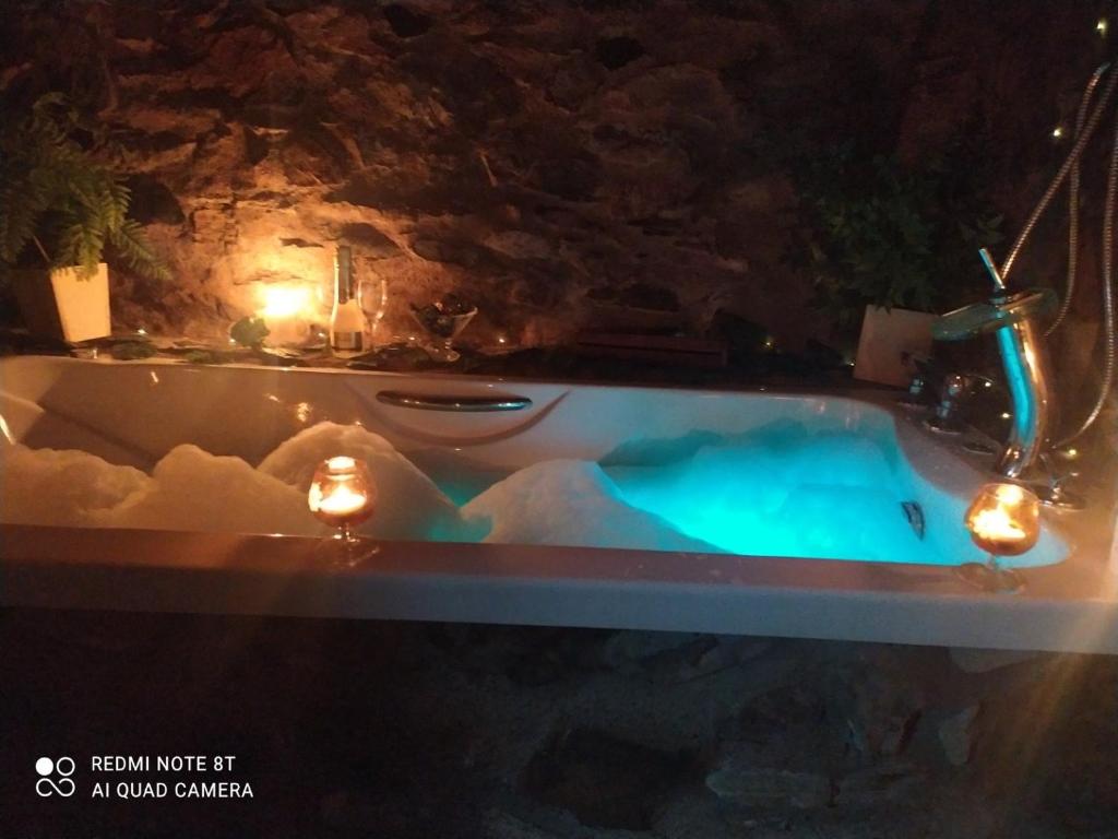 a bathtub in a cave with lights on it at La casa de los Bonales in Arroyomolinos de León