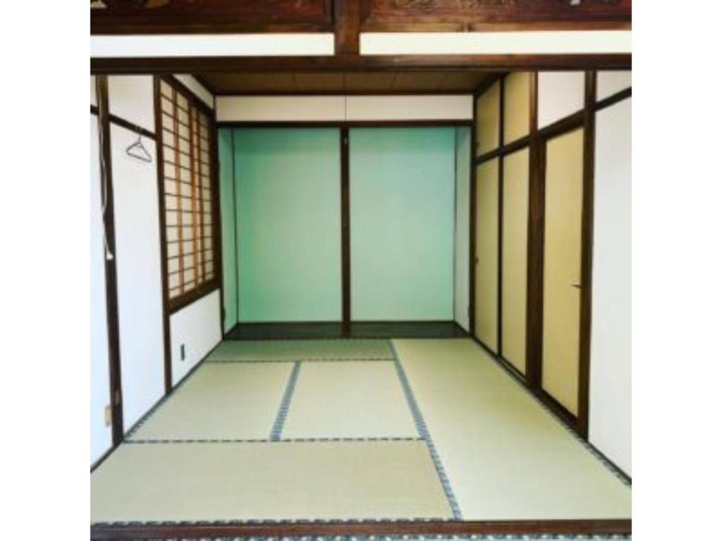 an empty room with glass doors in a building at Asobiyahouse Iki - Vacation STAY 30413v in Iki