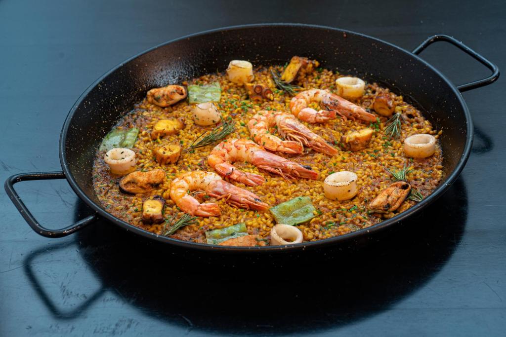 a pan full of food with shrimp and other ingredients at Arena Ipanema Hotel in Rio de Janeiro