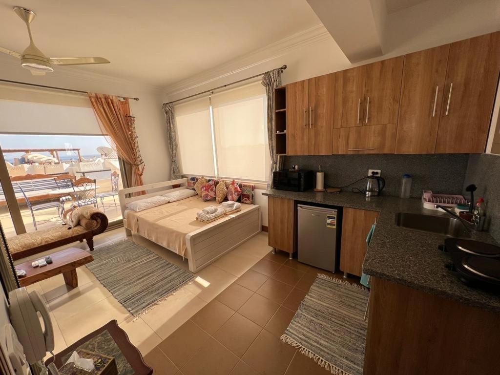 a kitchen and living room with a couch in a room at Villa D60 in Sharm El Sheikh