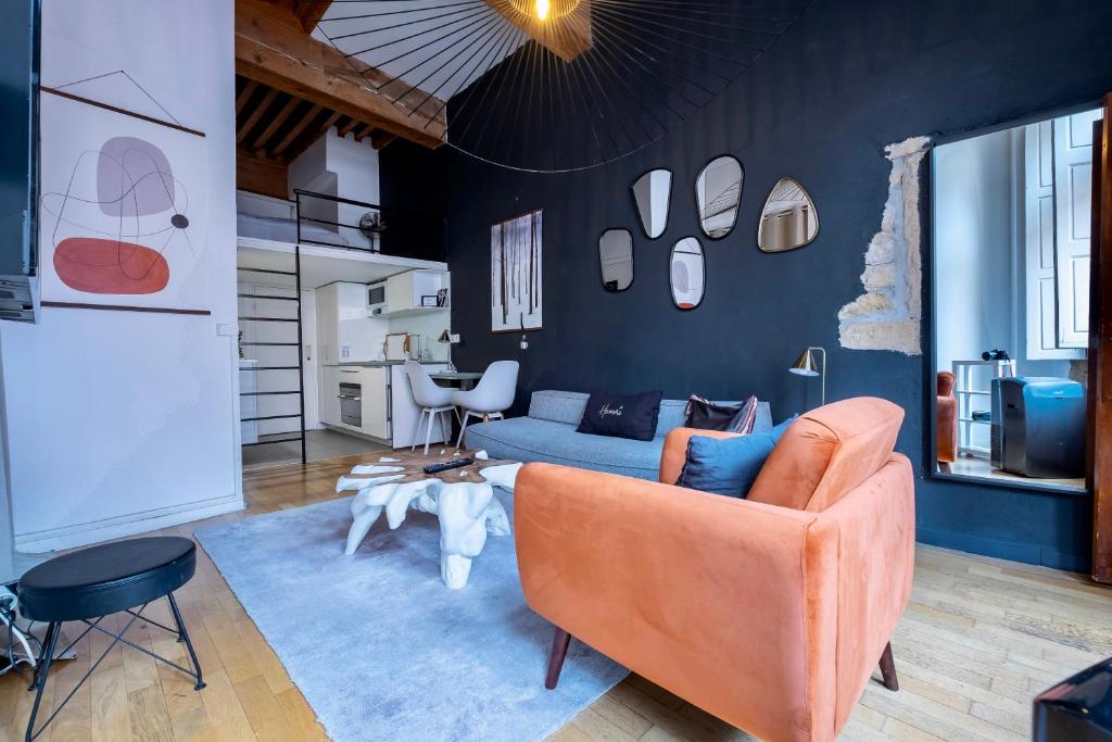 un salon avec un canapé et une table dans l'établissement Honorê - Suite Mercière, à Lyon