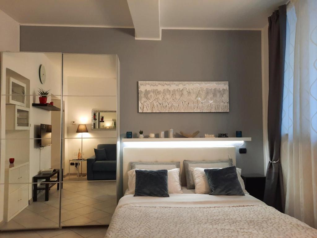 a bedroom with a bed and a living room at La Perla sul Lago di Como con parcheggio in Como