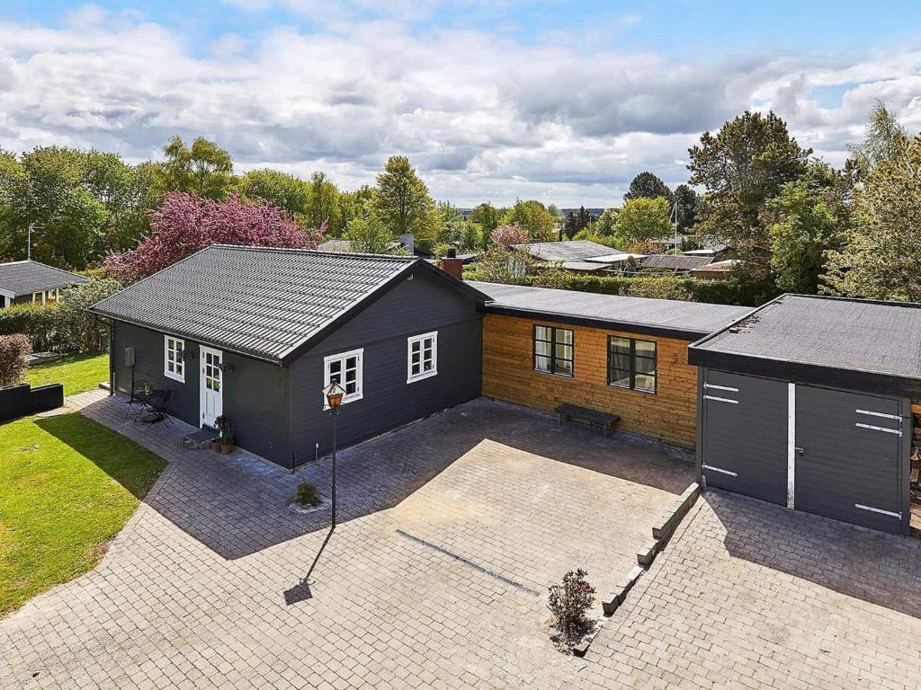 a small house with a courtyard in front of it at Holiday home Gilleleje LXXV in Gilleleje