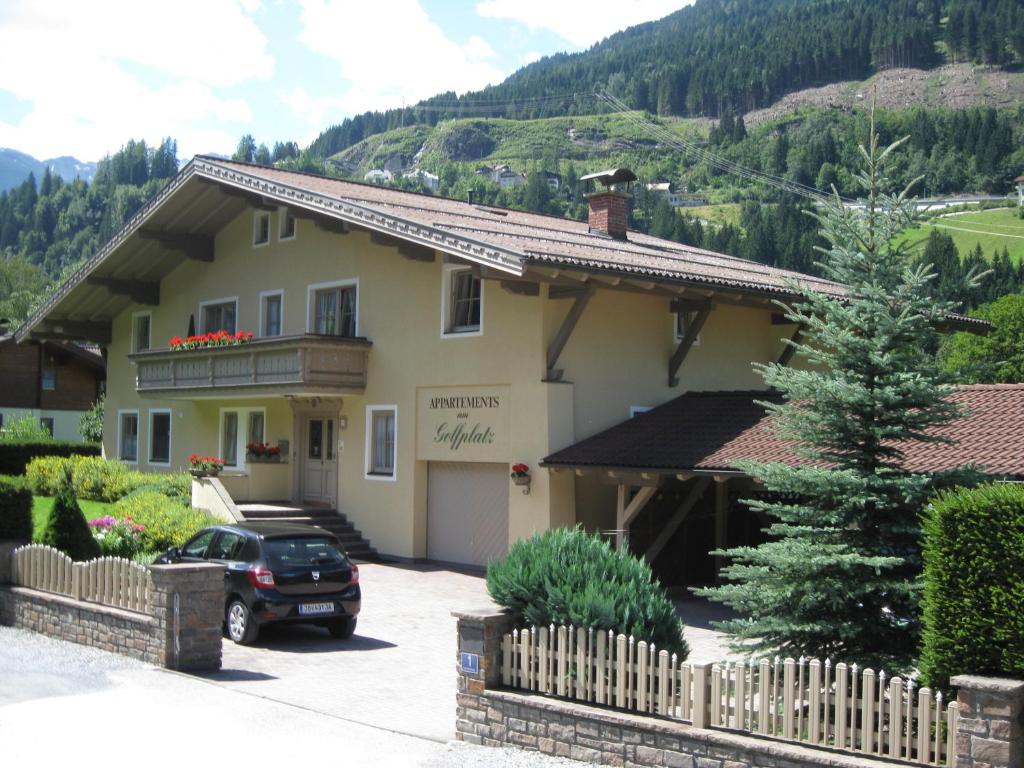 a house with a car parked in front of it at Golfappartements in Bad Gastein