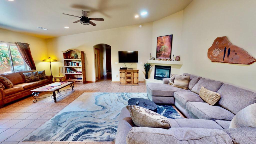 a living room with two couches and a tv at Arches East #389 in Moab