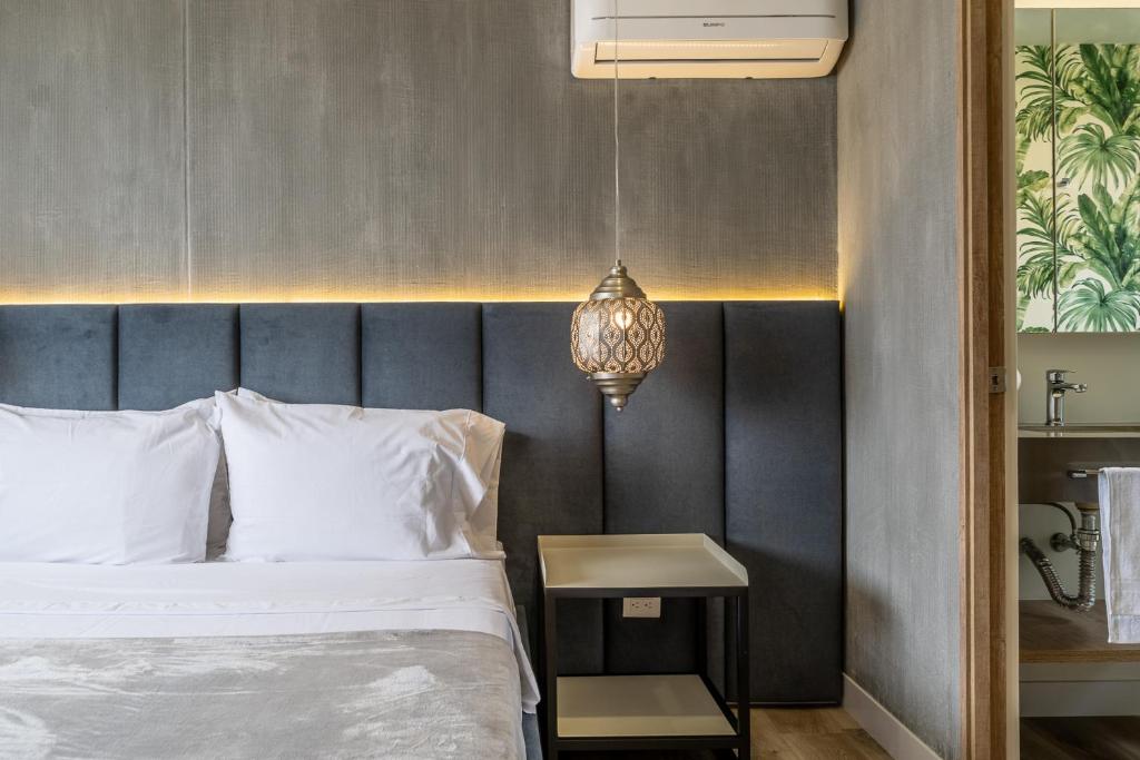 a bedroom with a bed and a pendant light at Apartamentos Go Living & Suites by HOUSY HOST in Medellín