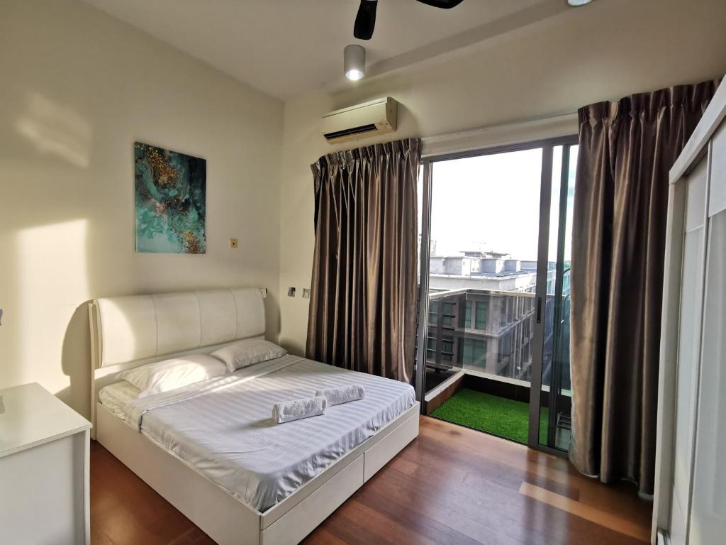 a bedroom with a bed and a large window at BC The Loft 3A Imago Studio in Kota Kinabalu