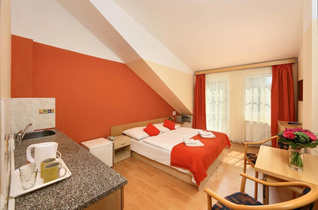 a hotel room with a bed and a kitchen at Residence Tabor in Prague