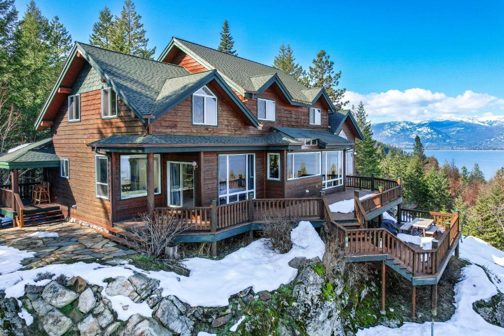 a house on a hill with snow at Moosewood Haven - Ideal Lakeside Retreat in Sagle