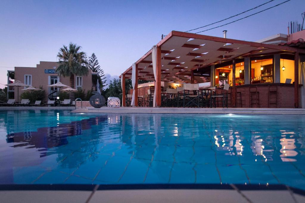 a swimming pool in front of a building at Hotel Peli in Kissamos