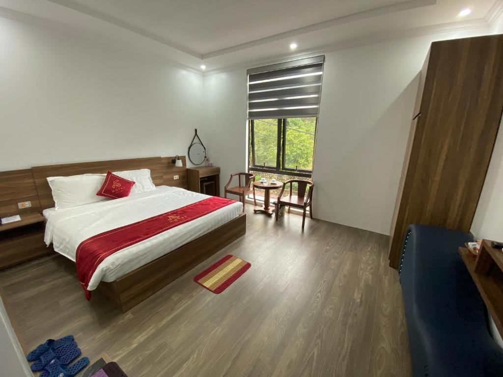 Schlafzimmer mit einem Bett, einem Tisch und einem Fenster in der Unterkunft Hotel A18 Lào Cai in Lào Cai