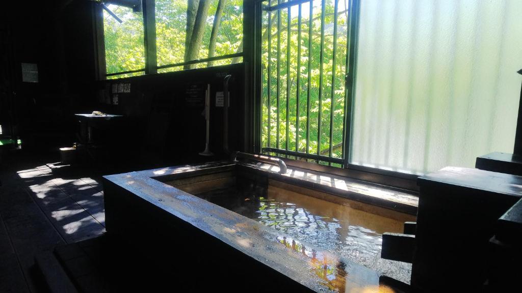 bañera en una habitación con ventana en Winkel Village, en Otaru