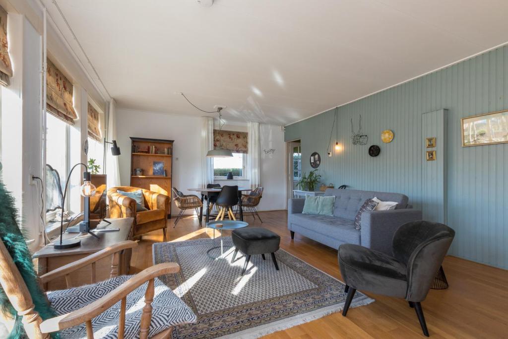 a living room with a couch and a table at Welcome in - Vakantiewoning in het centrum met tuin en airco, Zoutelande in Zoutelande