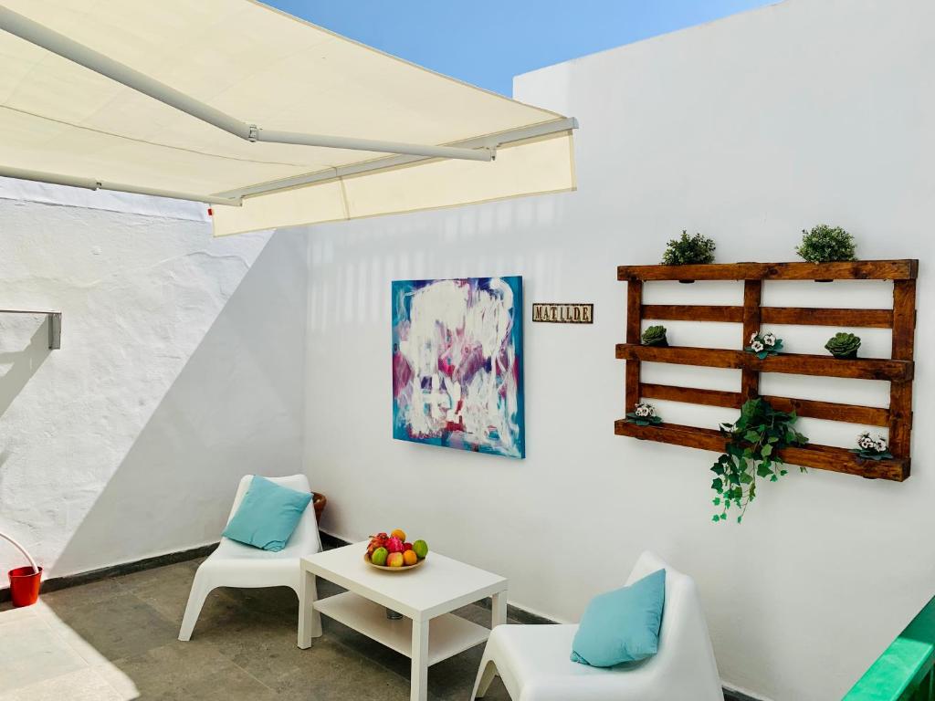 a living room with two chairs and a table at Marina in Tías