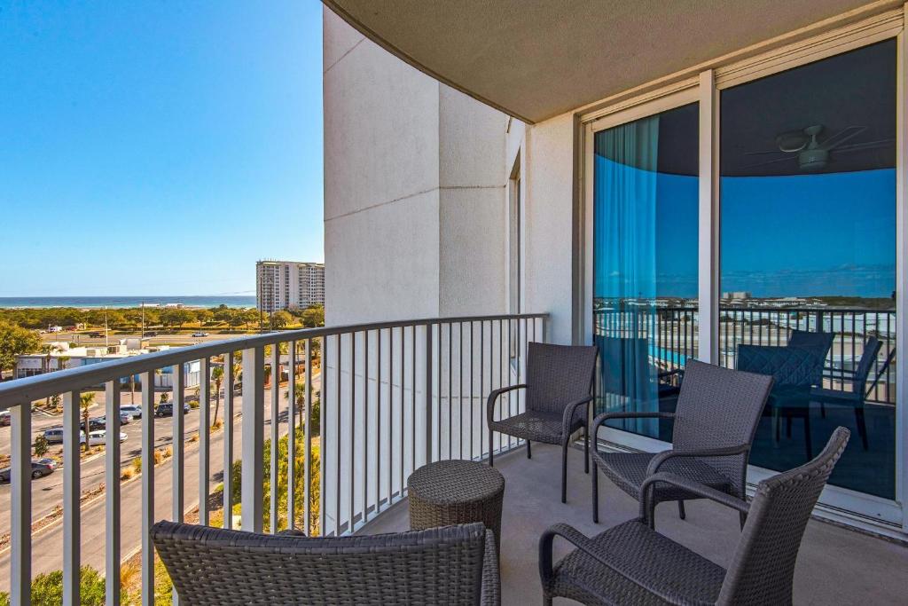 a balcony with chairs and a view of a highway at Palms Resort #1614 Jr. 2BR in Destin