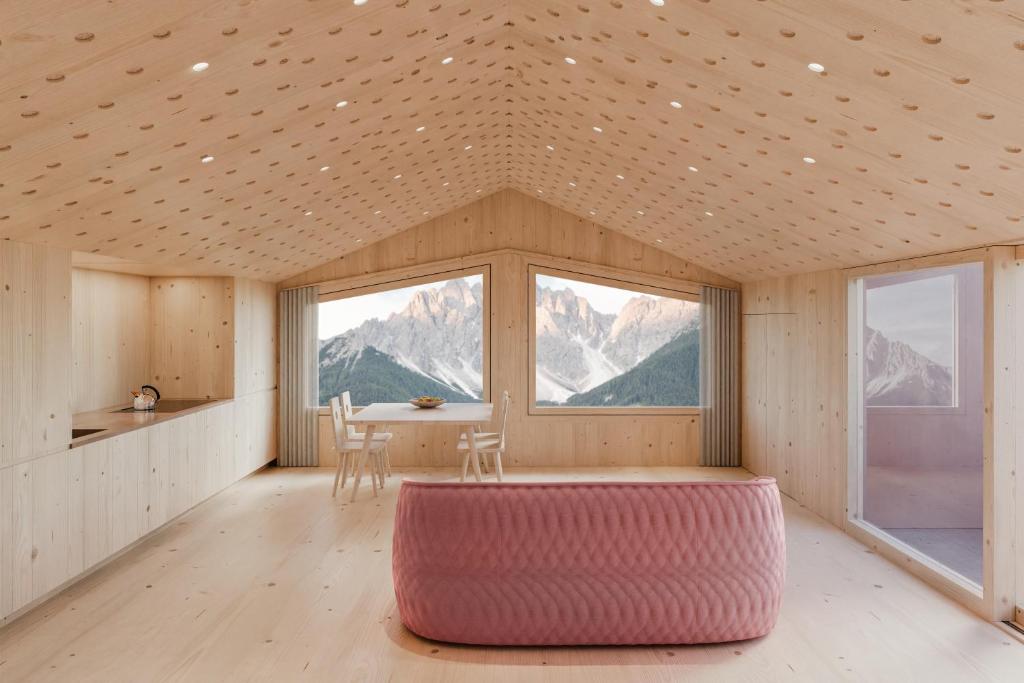a room with a table and a large window at ATTO - Suites & Cuisine in San Candido