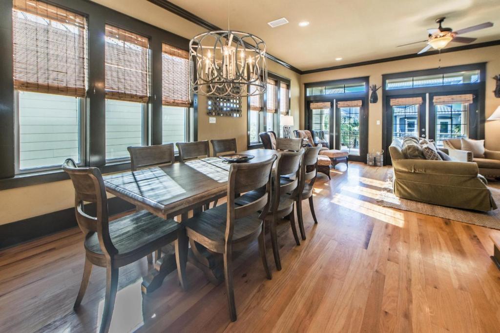 a dining room with a table and chairs at Comfort and Joy in Seacrest