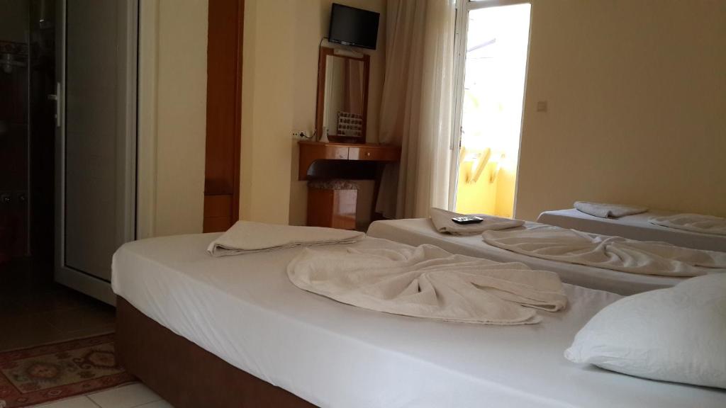 Postel nebo postele na pokoji v ubytování Caner Hotel