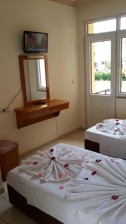 Postel nebo postele na pokoji v ubytování Caner Hotel