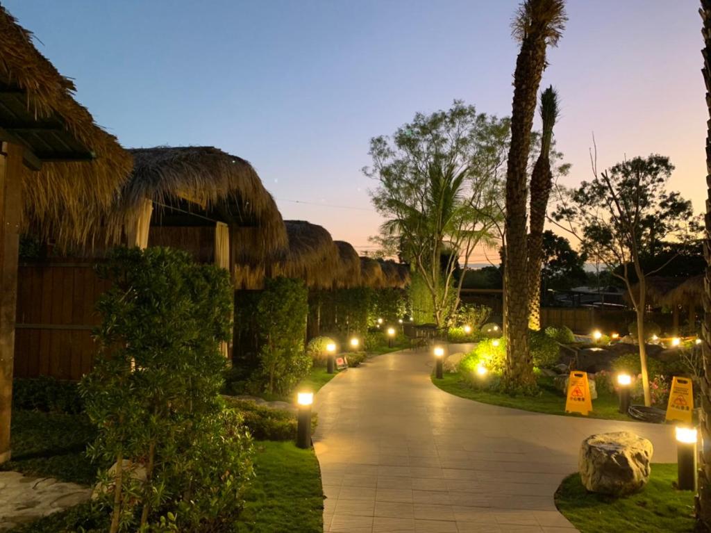 a walkway with lights in a resort at night at Yawan Hotel in Wenquan