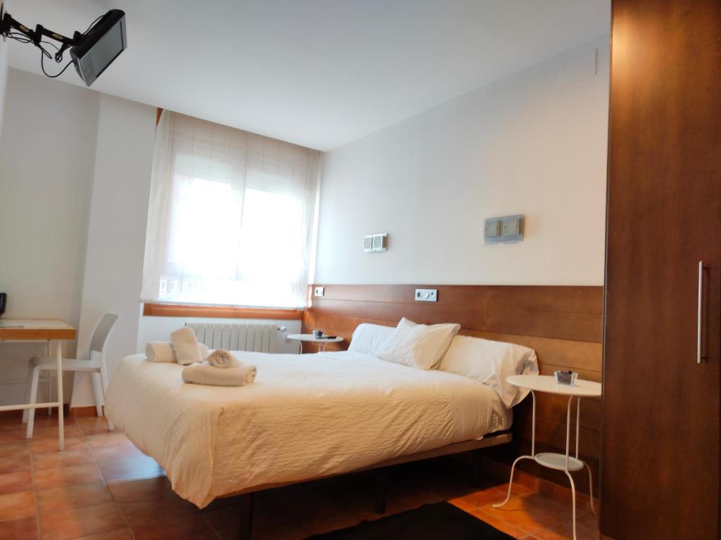 a bedroom with a large bed in a room at Hotel Cuéntame in Burgos