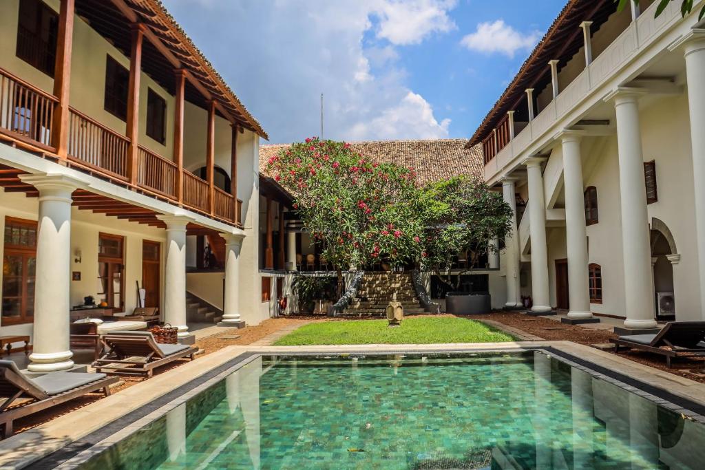 a swimming pool in the courtyard of a house at Galle Fort Hotel in Galle