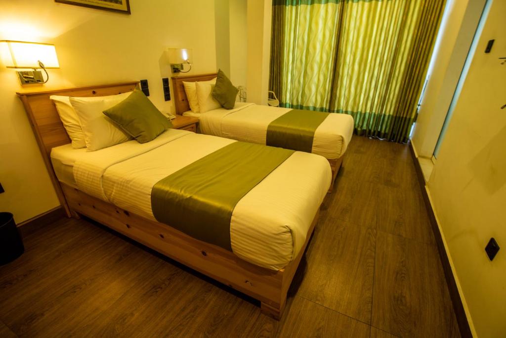 Postel nebo postele na pokoji v ubytování Hotel Ganthera Kandy