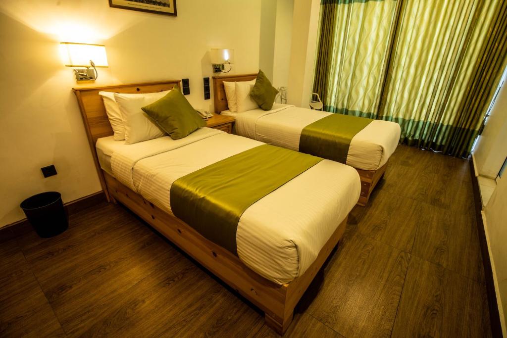 Postel nebo postele na pokoji v ubytování Hotel Ganthera Kandy