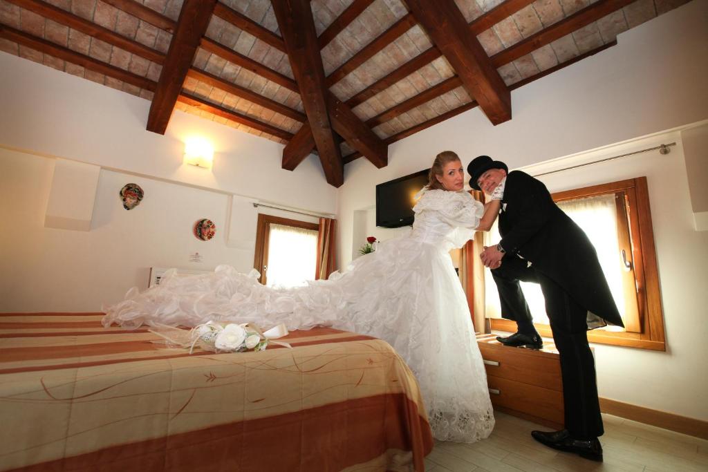 Postel nebo postele na pokoji v ubytování Albergo Antica Corte Marchesini