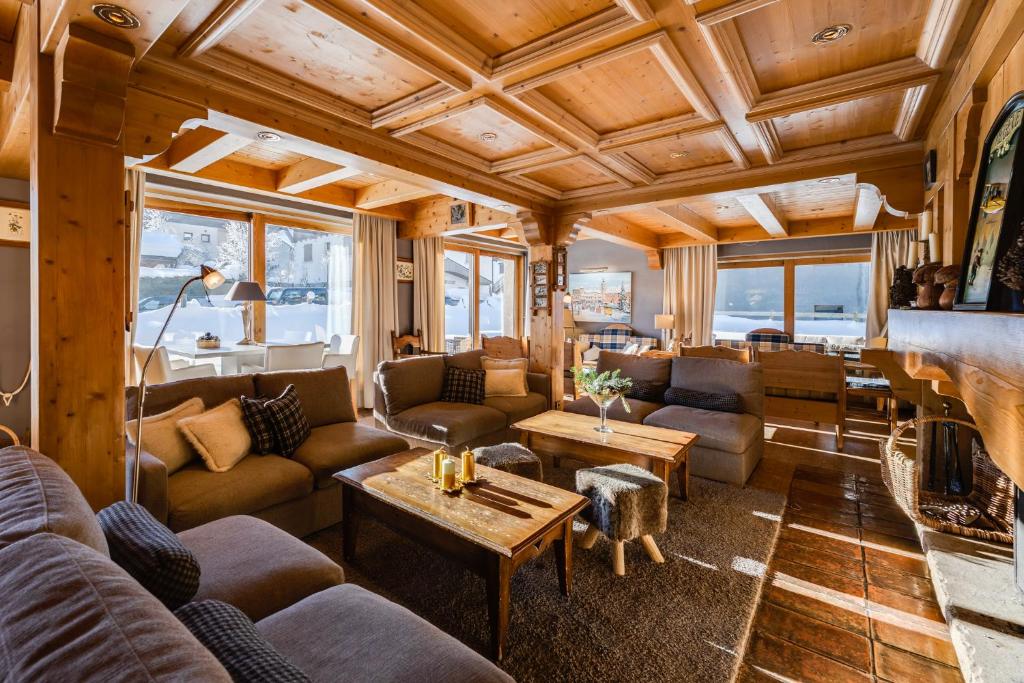 a living room with couches and a fireplace at Hôtel La Grange d'Arly in Megève