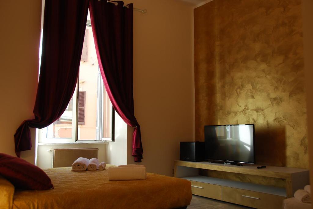 Televízia a/alebo spoločenská miestnosť v ubytovaní Home Art Colosseo