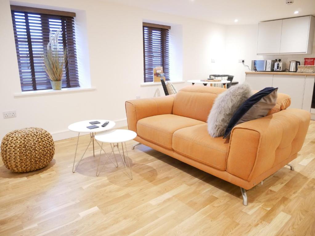 a living room with a couch and a table at Scandic Apartment, Ulverston in Ulverston
