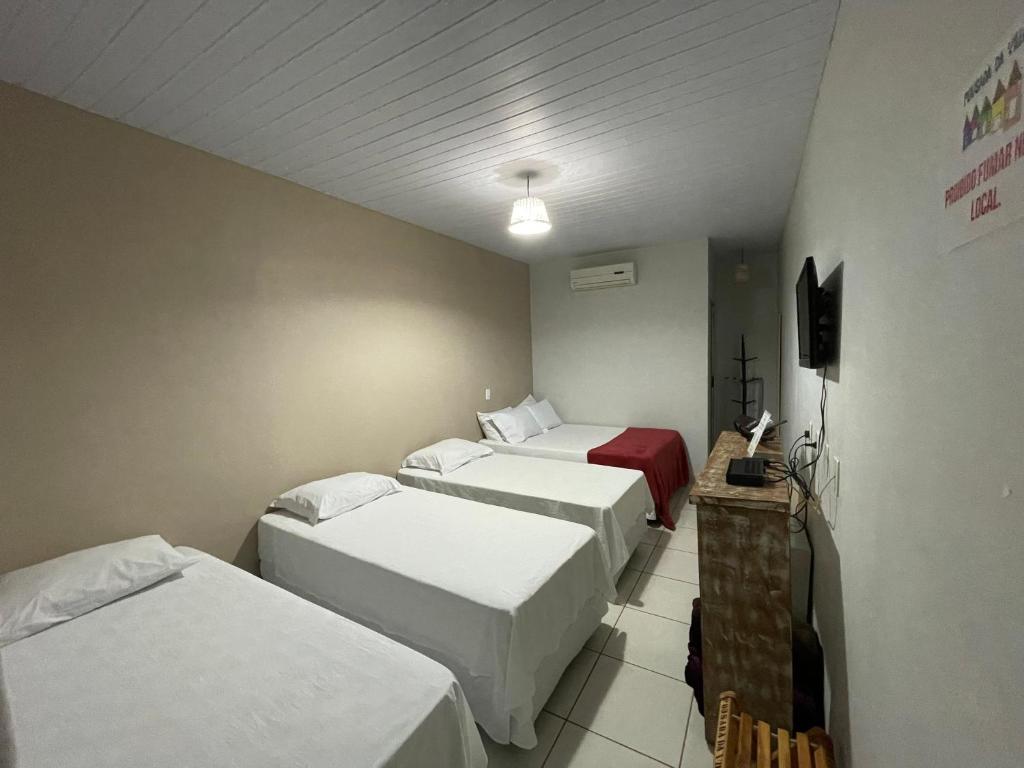 En eller flere senge i et værelse på Pousada da Villa