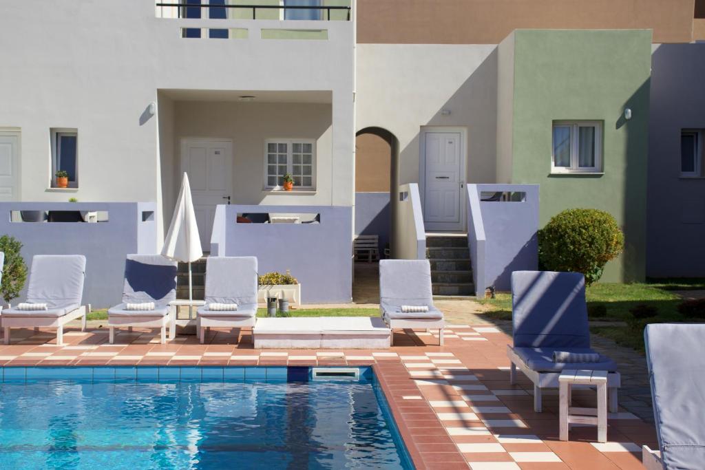 a group of chairs and a swimming pool at Golden Sun Boutique in Malia