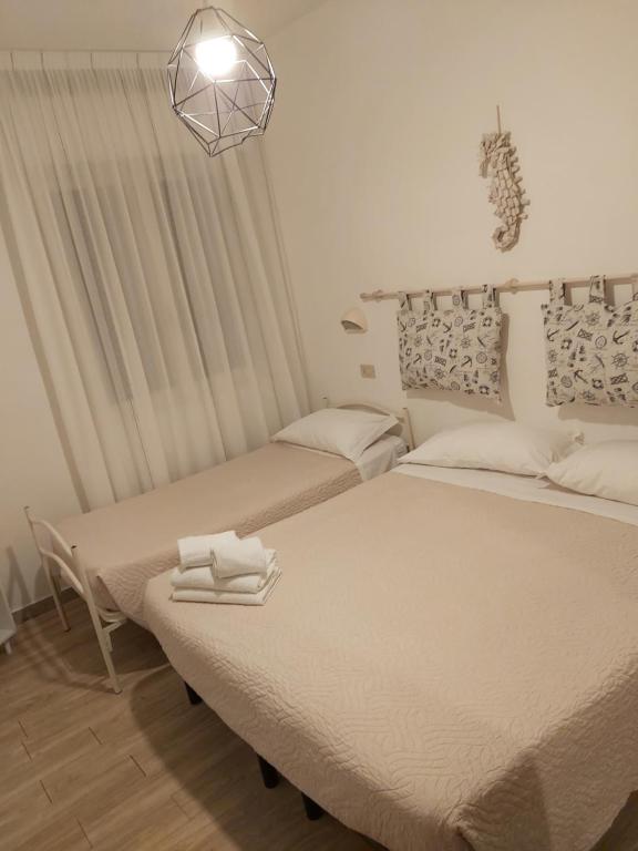 Postel nebo postele na pokoji v ubytování Hotel 21 Riccione