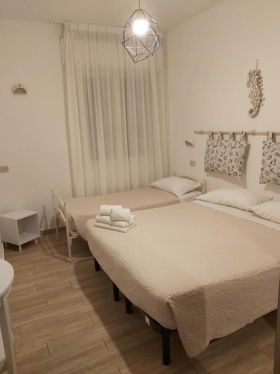 Postel nebo postele na pokoji v ubytování Hotel 21 Riccione