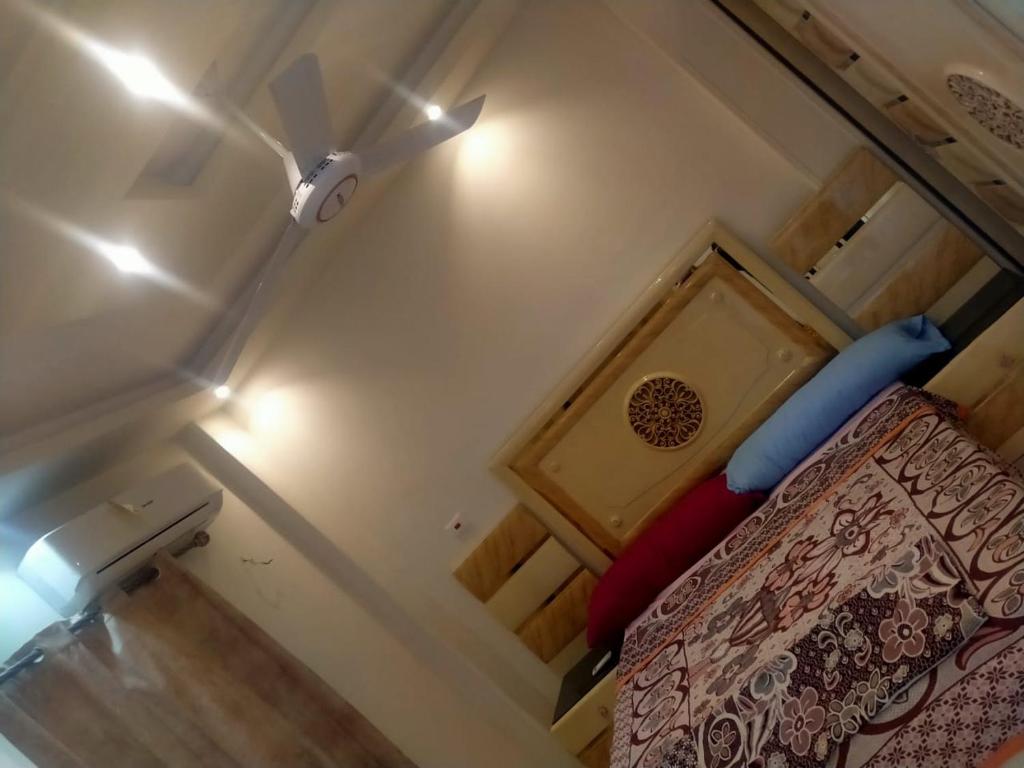 a bedroom with a bed and a ceiling fan at قرية رمسيس الكيلو45 الساحل الشمالي in Borg El Arab