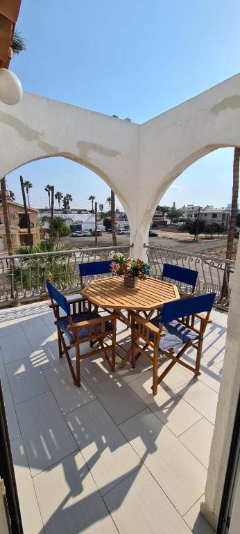 a wooden table and chairs on a patio at Lovely 1betroom apartment near the beach in Pyla