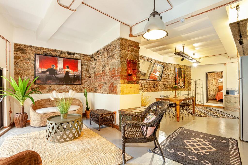 a living room with a brick wall at Origine Rentals Galata Tower in Istanbul