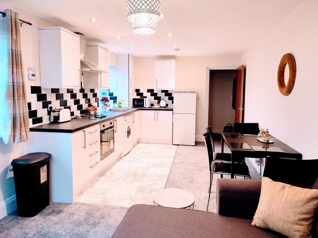 a kitchen with a table and a dining room at Crystal Suite 2 -free private parking in North Shields