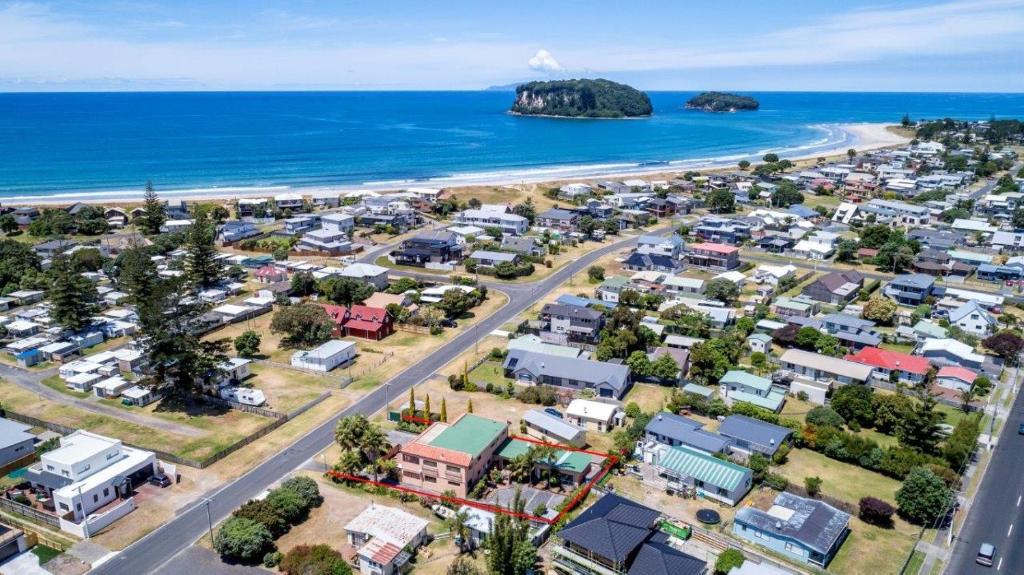 an aerial view of a suburb next to the ocean at La Dolce Vita Whangamata in Whangamata