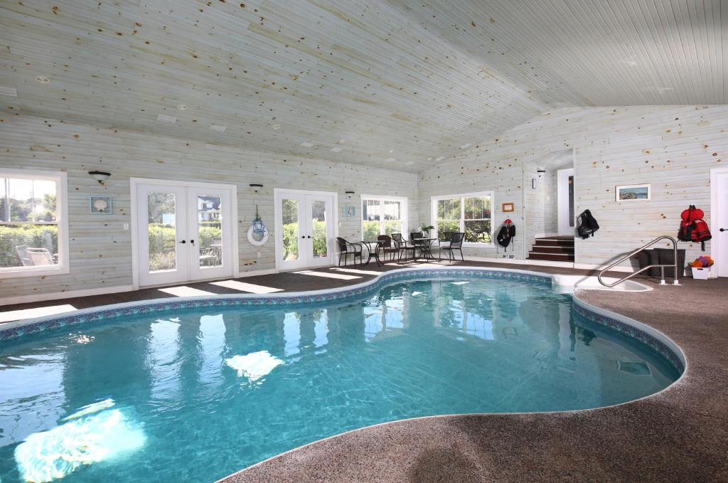 a swimming pool in a house with a wooden ceiling at Graham Inn in New Glasgow