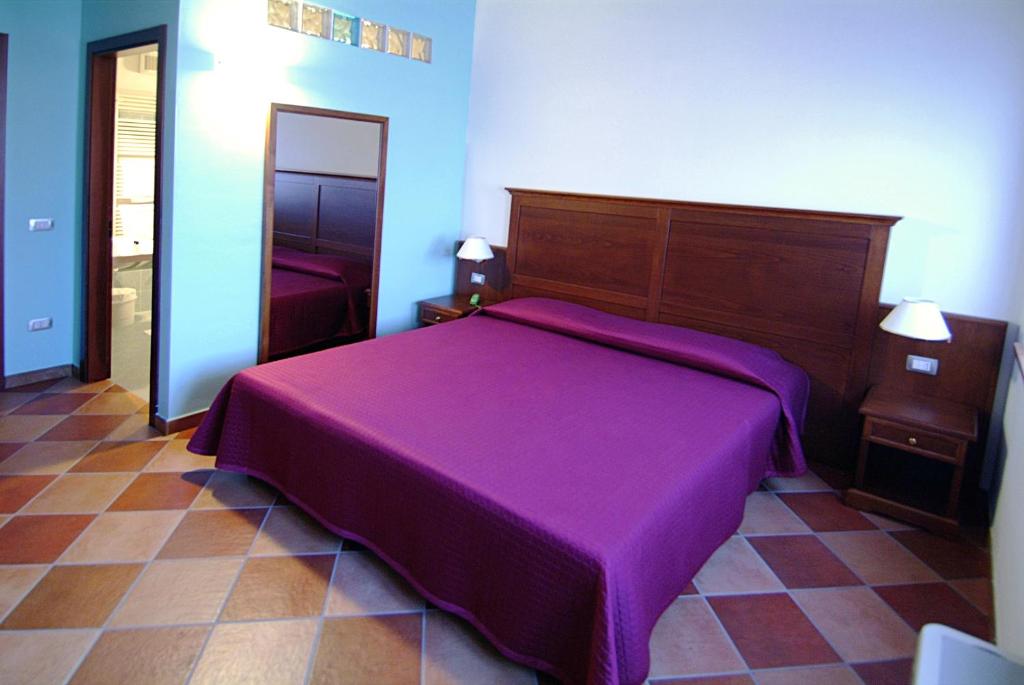 Postel nebo postele na pokoji v ubytování Corte Castelletto
