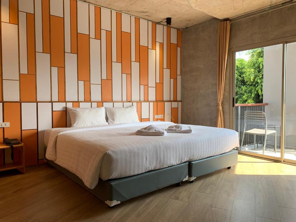 Uma cama ou camas num quarto em EcoLoft Hotel - SHA Plus