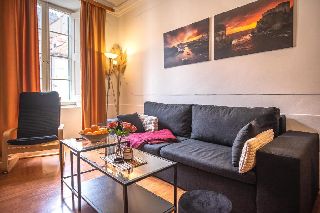 a living room with a couch and a table at Apartment Mari in Dubrovnik