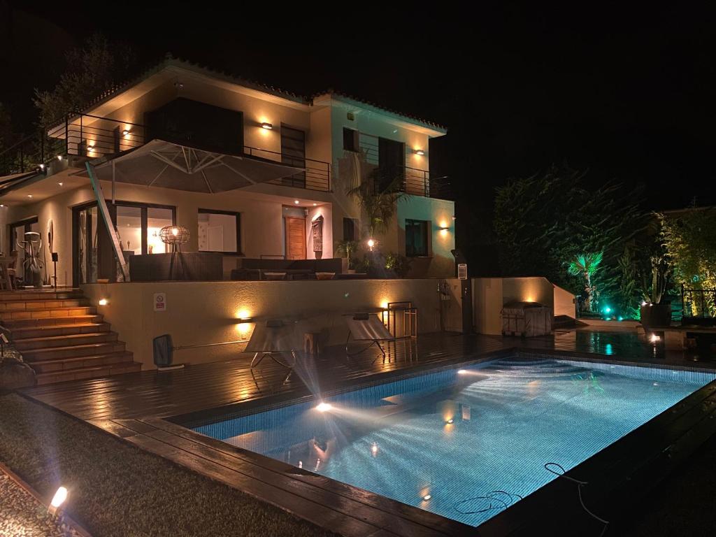 a swimming pool in front of a house at night at Casa Tanio 150m walking from the village and town of Tamariu in Tamariu