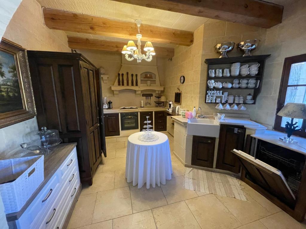 a large kitchen with a table in the middle of it at Betty Cake B&B in Qala