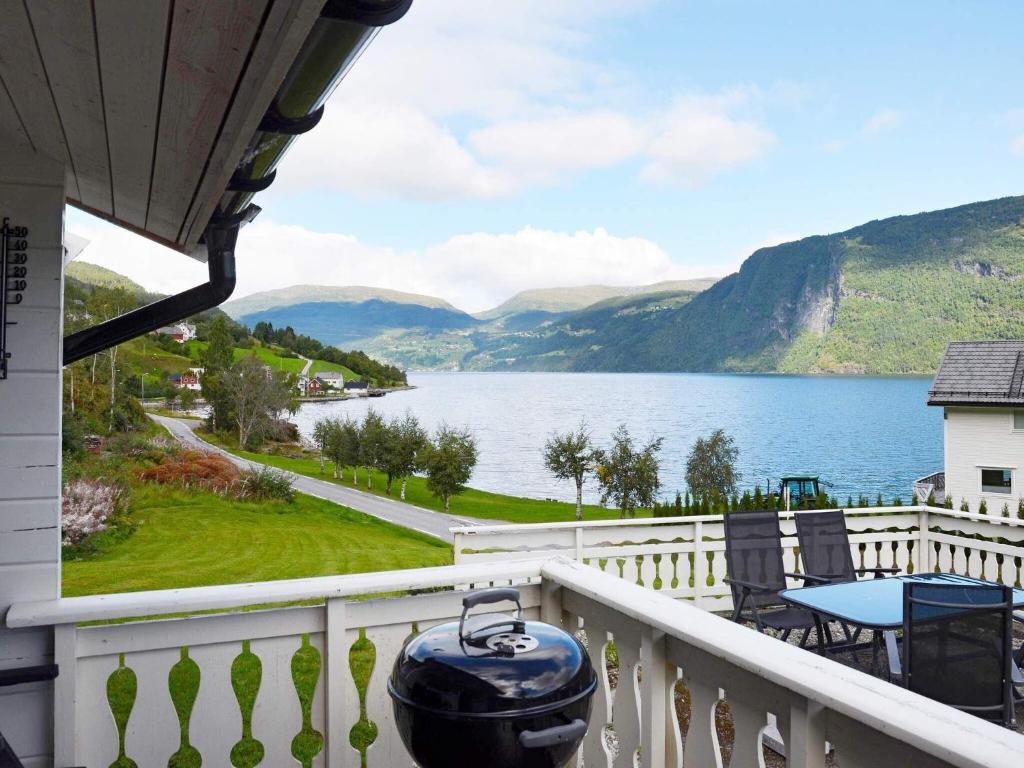 a balcony with a view of a lake and mountains at Holiday home Utvik III in Utvik